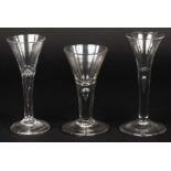 Three 18th Century wine glasses of drawn trumpet form with tear included stems,