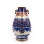 A Chinese zun vase, Qing dynasty, decorated in underglaze red and blue,