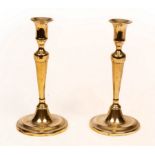 A pair of late 18th Century silver plated brass candlesticks,