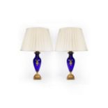 A pair of blue glass vase-shaped table lights, with gilt brass scroll handles and mounts,