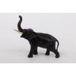 A Japanese bronze figure of an elephant, Meiji period, with ivory tusks, signed beneath one foot,