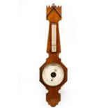An oak cased barometer by Dollond,