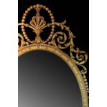 A fine giltwood and gesso oval wall mirror of 18th Century style,