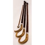 Three walking sticks with horn handles and silver collars,