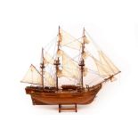 A scale model of a three-masted ship on stand,