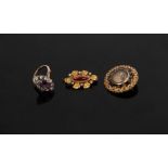 A paste set dress ring, the central purple stone to a surround of clear stones, size N½,