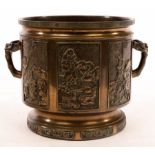 A Japanese bronze Hibachi, decorated panels of figures and with ring handles,