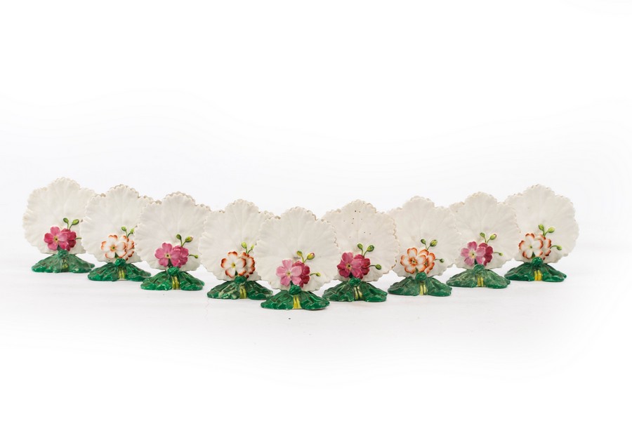 A collection of nine Brownfield leaf-shaped floral menu holders,