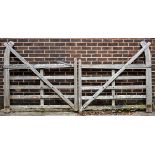 A pair of five-bar cranked teak gates with curved hook backs to both sides,