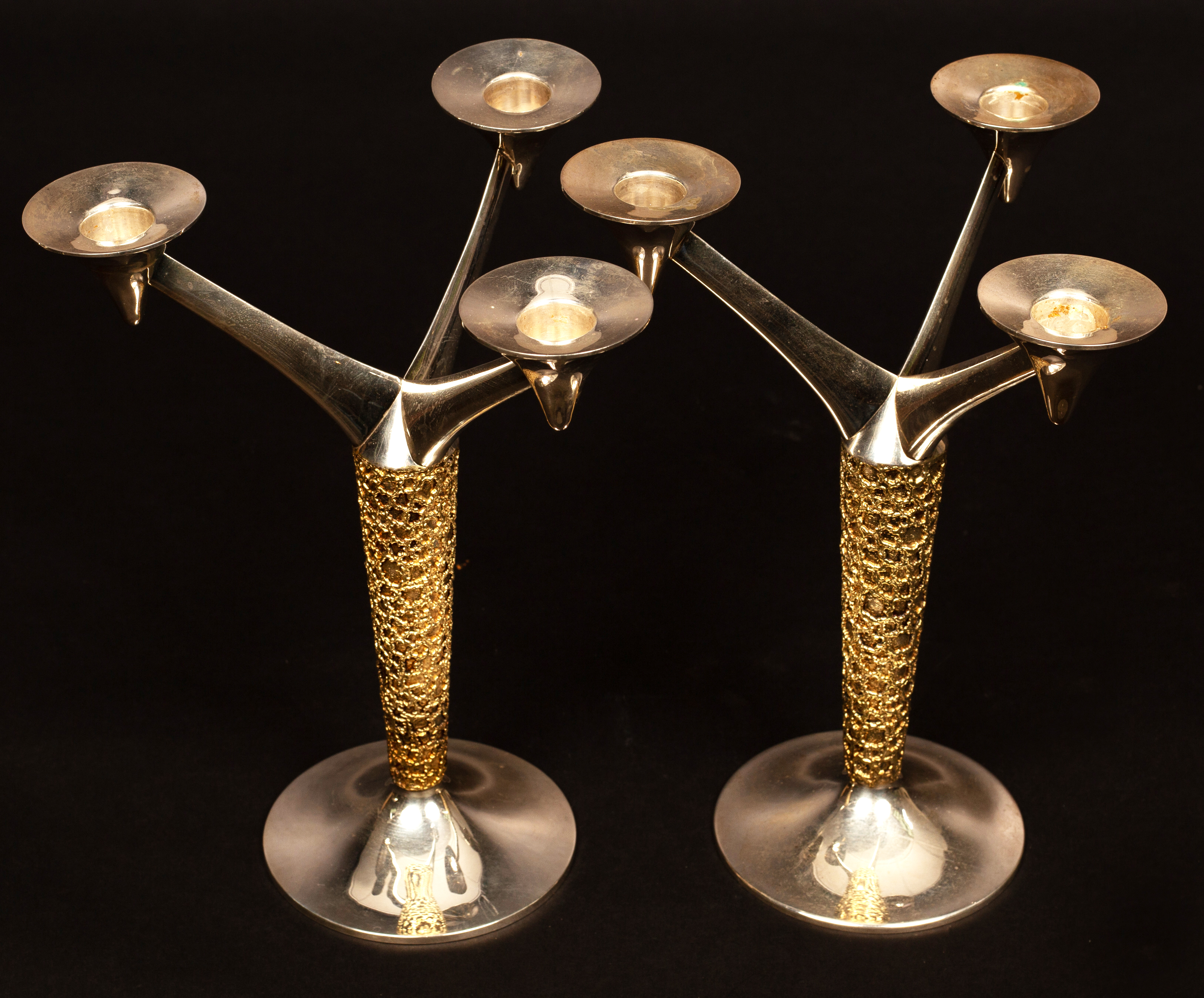 Stuart Devlin (1931-2018), a pair of silver and silver-gilt three-light candelabra,