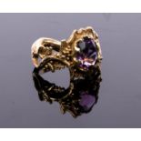 A 1960s 9ct gold and amethyst ring, of modernist design with scrolling vines,