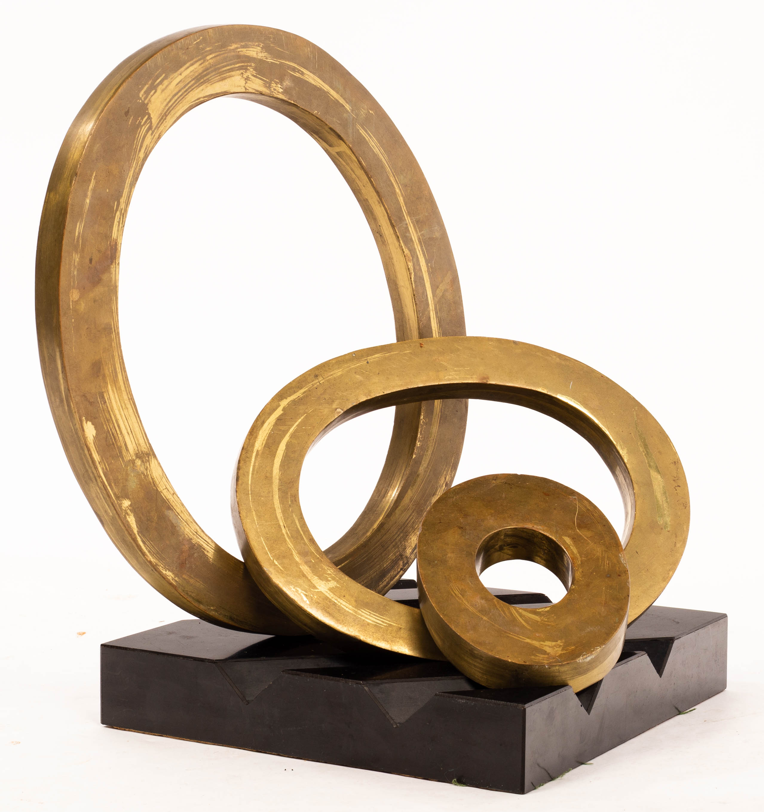 H Simon, a modernist sculpture of three bronzed interchangeable rings on a black ridged base,