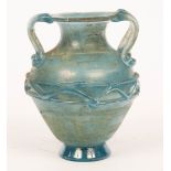 A twin-handled blue glass vase of amphora shape, with band of trailed decoration around the middle,