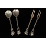 Georg Jensen: A pair of silver spoons and a pair of pickle forks,