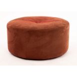 A modern Italian circular ottoman upholstered in fabric with button to centre,