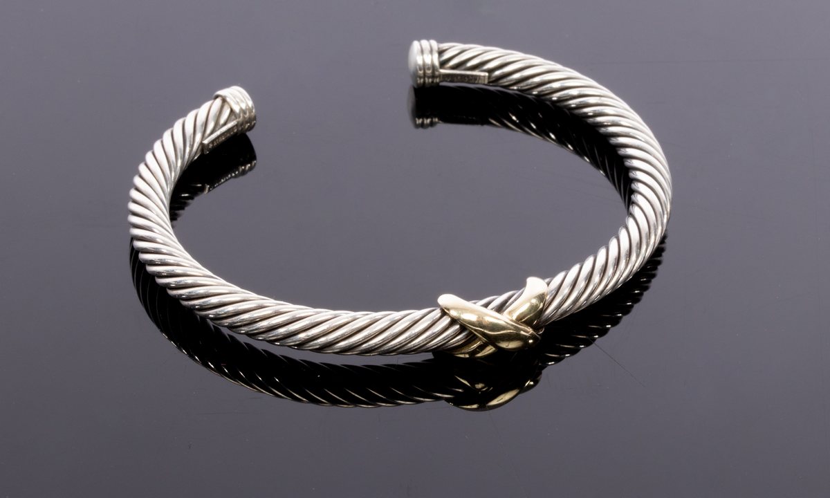 David Yurman, a silver and gold cable bangle, with central 14ct yellow gold cross, signed,