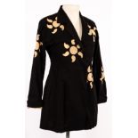 Issey Miyake, a black cotton 'sunshine' jacket with decorative cut-out designs,