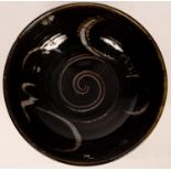 John Christie (20th Century), a large circular bowl in tenmoku glaze, impressed mark,