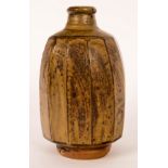 Phil Rogers (1951-2020)/A stoneware bottle vase with facetted body, green ash glaze,
