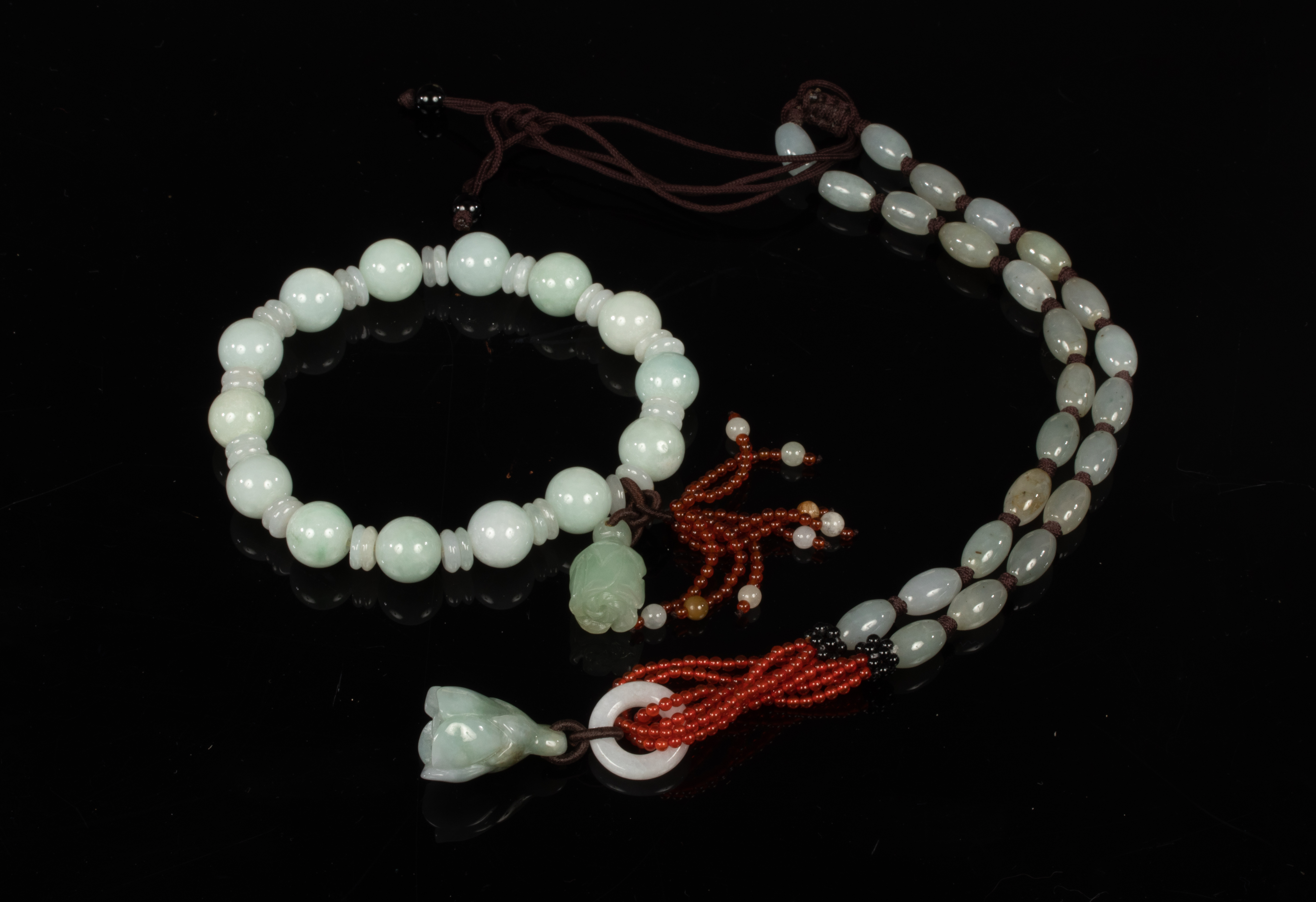 A jade bead bracelet, a similar necklace and three costume necklaces, etc.