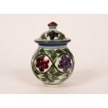 Laurence McGowan (born 1942), a lidded stoneware jar, coloured flowers and foliage,