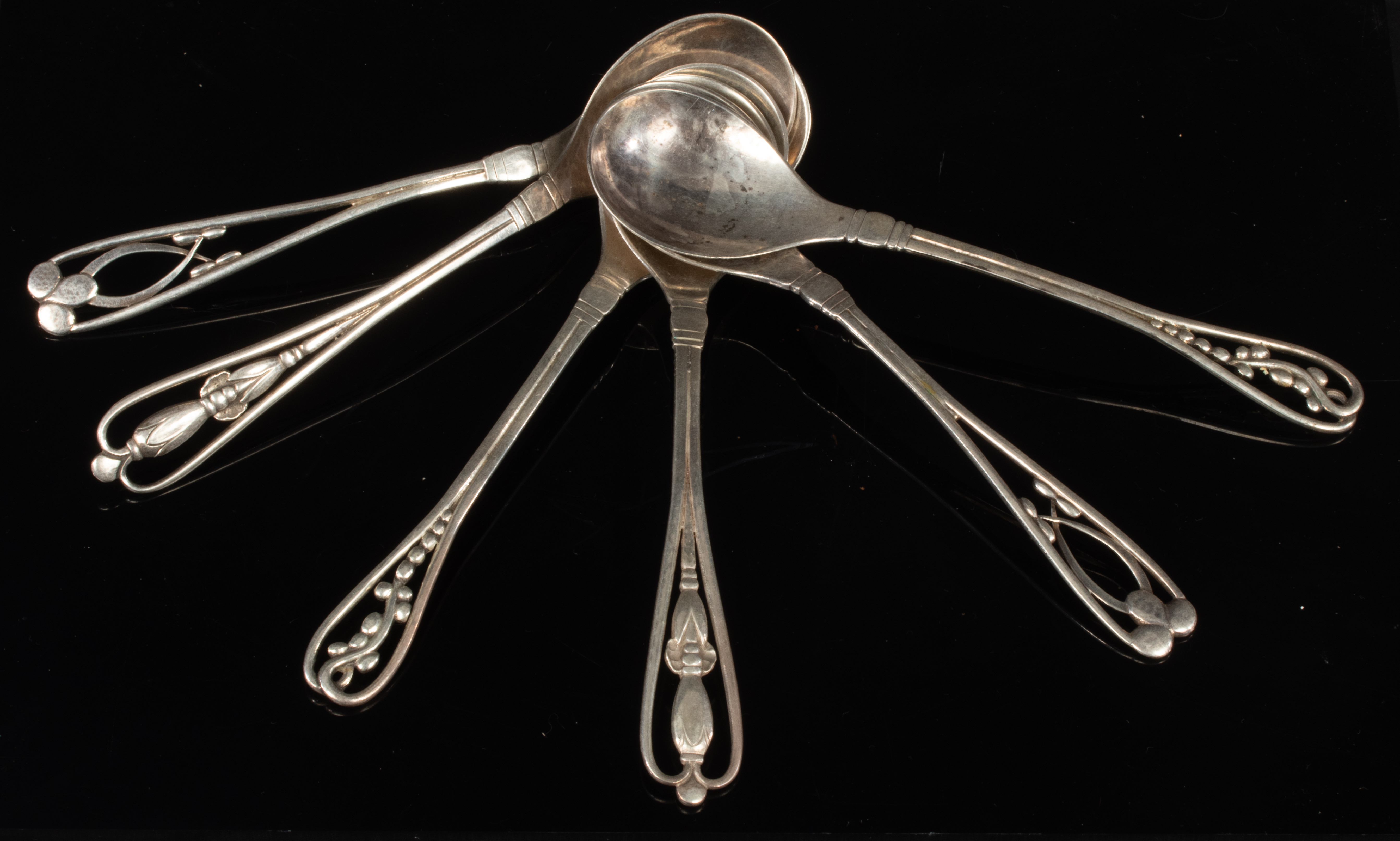 Georg Jensen: Three pairs of silver spoons with stylised terminals (Nos 151,