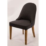 An OKA office chair, upholstered in grey material and with piped border,