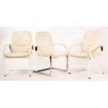 Three Froscher armchairs, one with chromium frame, the others with white laminate frames,