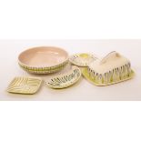 Poole Pottery, a patterned cheese dish and cover, 18cm long, a patterned shallow bowl,