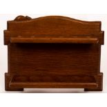 A Robert 'Mouseman' Thompson oak pipe rack, with six sections and an arched top,