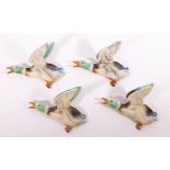 Poole Pottery, a set of four flying duck wall mounts, impressed no.