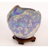 A Studio ceramic vessel, of rounded form with irregular top, mottled blue,