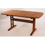 Ercol, a light elm extending dining table, the curved corners with incised decoration,