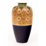 A Royal Doulton stoneware vase with band of gilt floral decoration above a blue glaze,