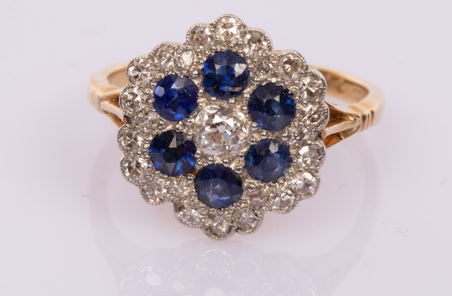 A diamond and sapphire flowerhead cluster ring,