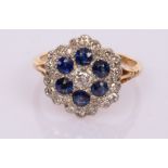 A diamond and sapphire flowerhead cluster ring,