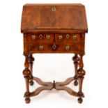 A small Queen Anne walnut bureau, circa 1690, on original stand and cross stretchers,