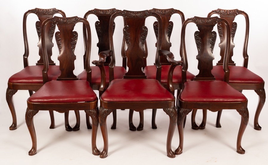 Seven George I style mahogany dining chairs with vase-shaped splats and loose trap seats,