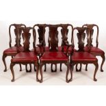 Seven George I style mahogany dining chairs with vase-shaped splats and loose trap seats,