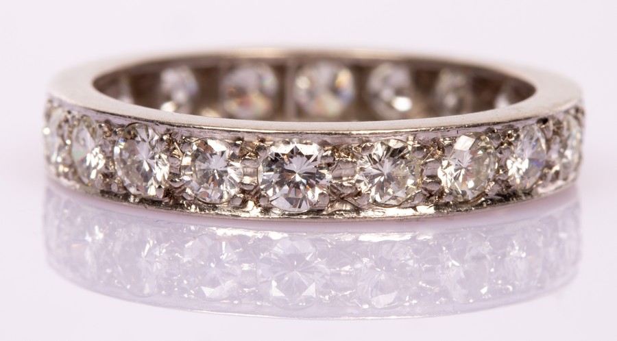 A diamond eternity ring set with twenty brilliant cut stones in a platinum mount,