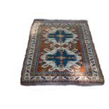 A Hamadan rug with two geometric medallions to an orange ground within a figured border,