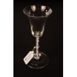 An 18th Century ale glass with bell-shaped bowl on a drawn mercury twist stem and circular base,