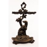 A 19th Century black painted cast iron umbrella stand modelled as a hound seated under a tree,