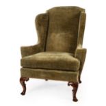 A Howard & Sons Queen Anne style upholstered wingback armchair, circa 1920,