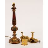 A carved and painted table lamp, a brass chamber candlestick,