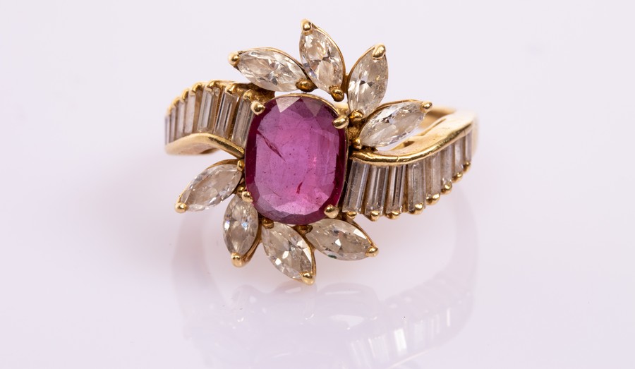 A ruby and diamond dress ring, the central oval ruby of approximately 1.