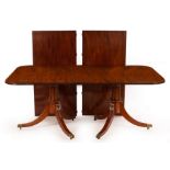 A Regency stye mahogany twin pedestal dining table, by Arthur Brett, with two extra leaves,