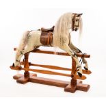 An early 20th Century rocking horse by F H Ayres, with glass eyes, open mouth and projecting tongue,