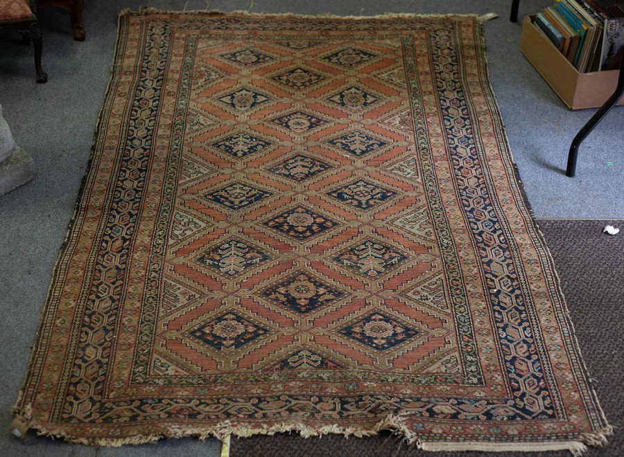 A Caucasian rug, the central field of seventeen medallions within a stylised multi figured border, - Image 2 of 2