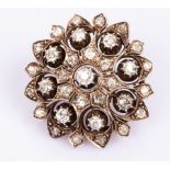 A diamond brooch, circa 1890, the stylised flowerhead of openwork design,